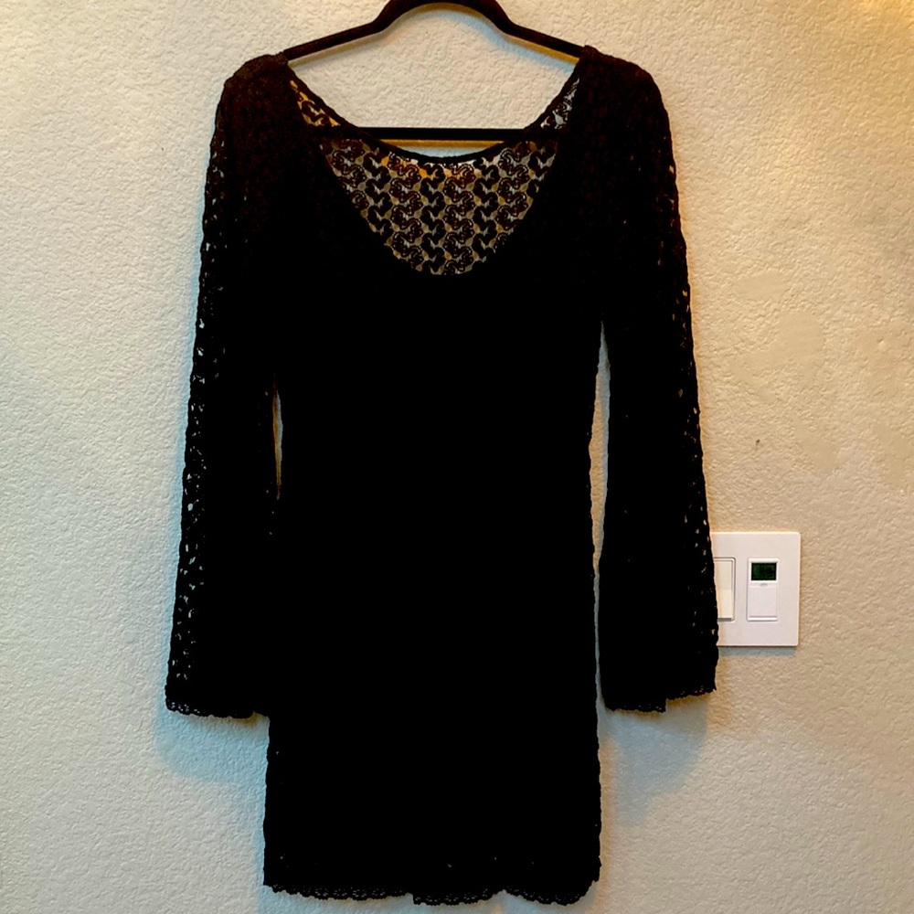 Super cute knit bel sleeves and low back black dress.